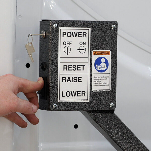 Hand pressing the button to raise the upper deck of the DD2000-XLC