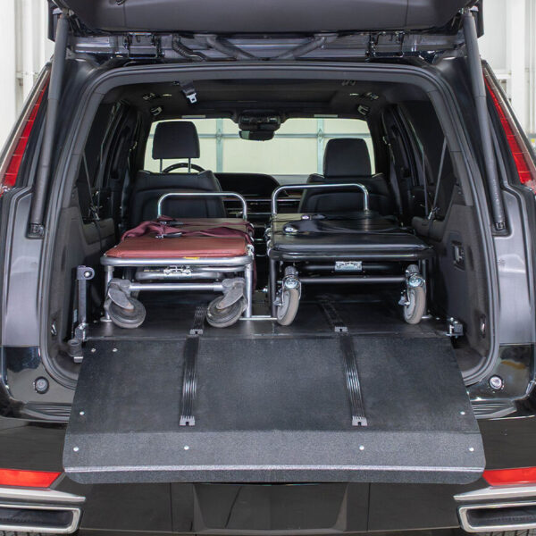 An oversized and standard cot secured side by side in a SR75 mini deck system in a Cadillac Escalade