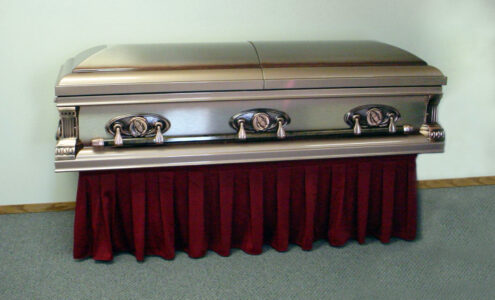 Casket displayed on casket truck with red D400 drape