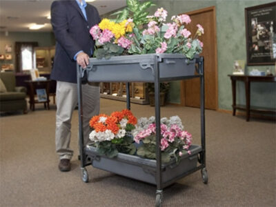 Man moving flowers with FC40 flower cart