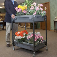 Man moving flowers with FC40 flower cart
